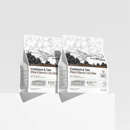 Two 2.5kg bags of FluffyMW Cassava and Tea Plant Blend Cat Litter displayed on a minimalist white pedestal, showcasing the clean, modern packaging design.