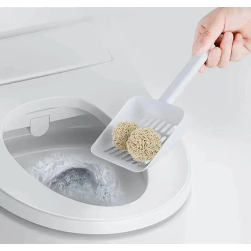 A person scooping solid clumps of KUNGFU CAT tofu litter directly into a toilet. Demonstrates the highly water-soluble, flushable, and eco-friendly nature of the product.