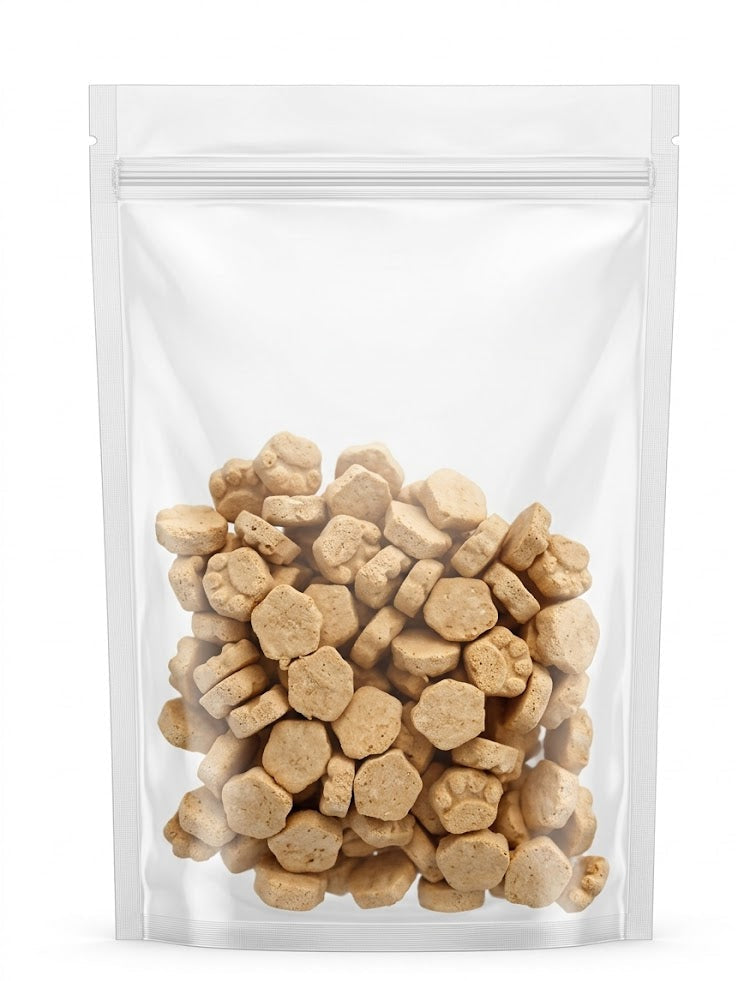 A clean studio view of a clear stand-up pouch filled with premium freeze-dried cat and dog treats, showcasing the adorable paw and hexagon shapes made with a minimum of 65% crude protein.