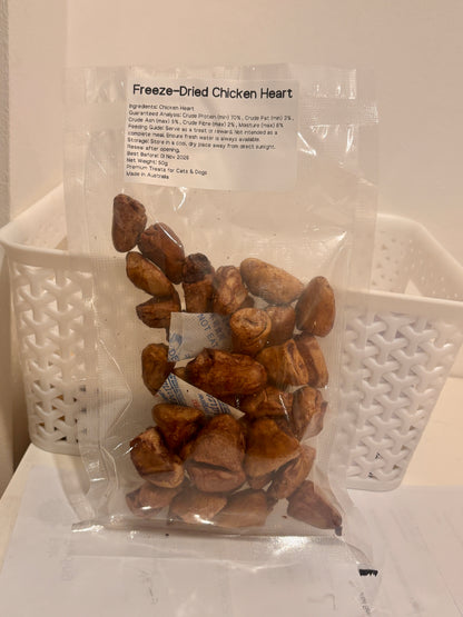 A clear, resealable 50g bag of Freeze-Dried Chicken Heart pet treats, featuring a printed label that highlights the 100% single-ingredient formula, 70% crude protein, and Australian Made quality.