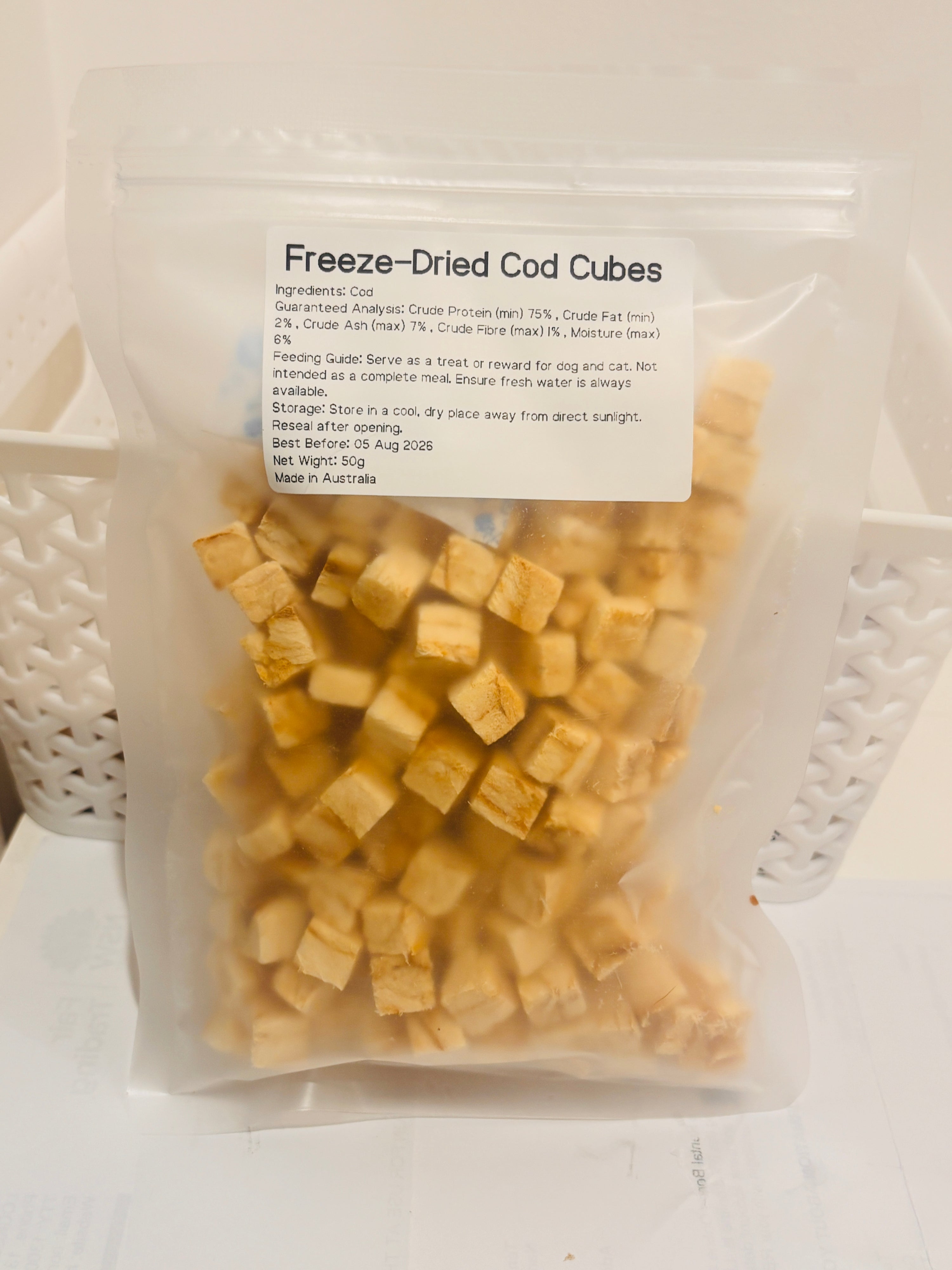 A clear, resealable 50g bag of Freeze-Dried Cod Cubes, featuring a printed label that details the 100 percent cod formula, 75 percent minimum crude protein, and Australian Made quality.