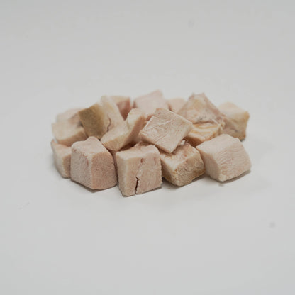 A close-up pile of Rafa Raw freeze-dried crocodile steak cubes. Light, neutral-flavored white meat single-ingredient treats perfect for fussy eaters and pets with severe food allergies.