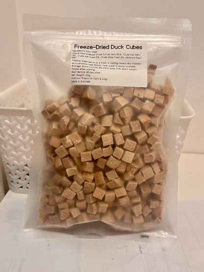A clear, resealable 100g bag of Freeze-Dried Duck Cubes, featuring a printed label that details the 100 percent duck meat formula, 65 percent minimum crude protein, and Australian Made quality.