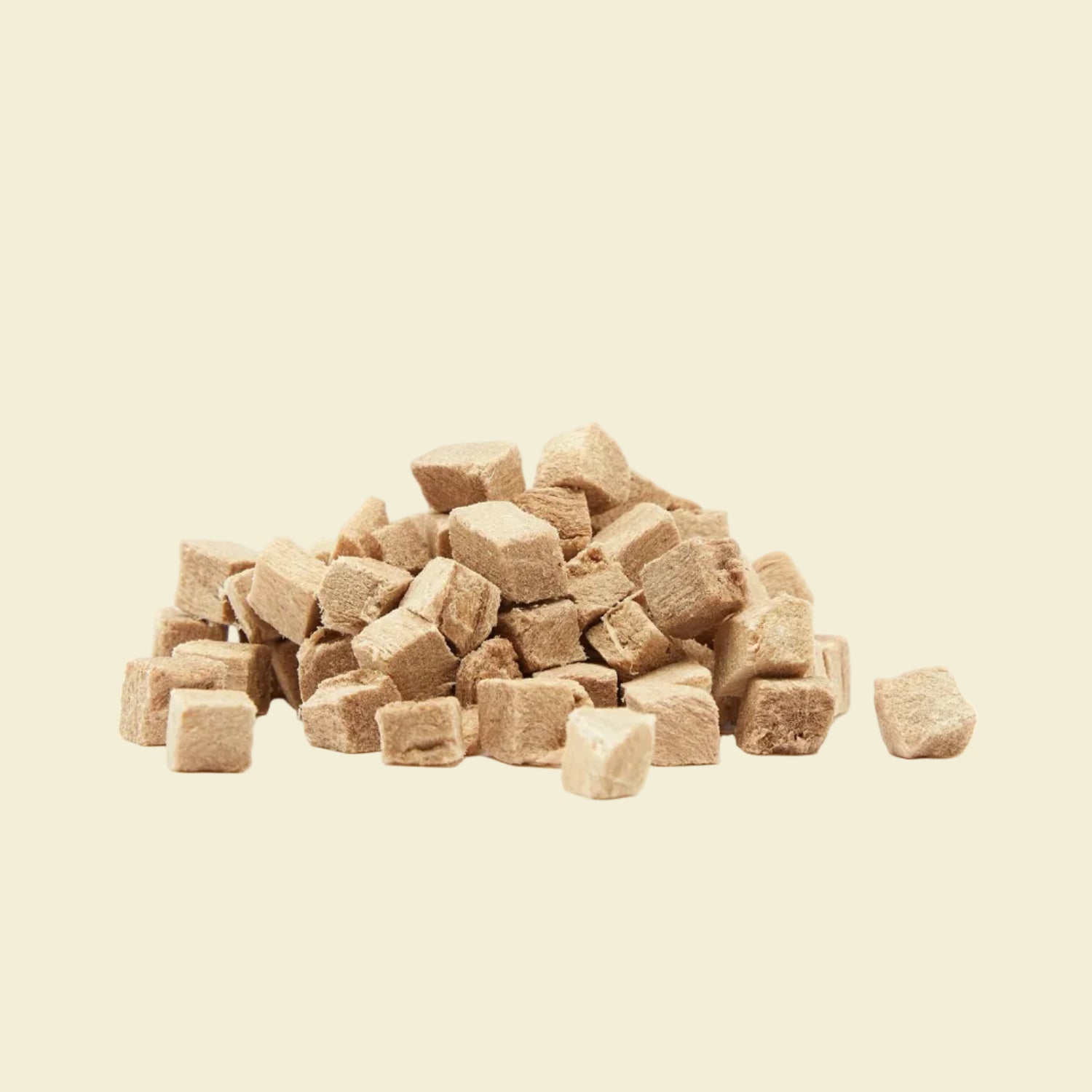 A pile of uniform, bite-sized freeze-dried duck cubes on a white background, highlighting a clean, single-ingredient hypoallergenic training treat for pets.