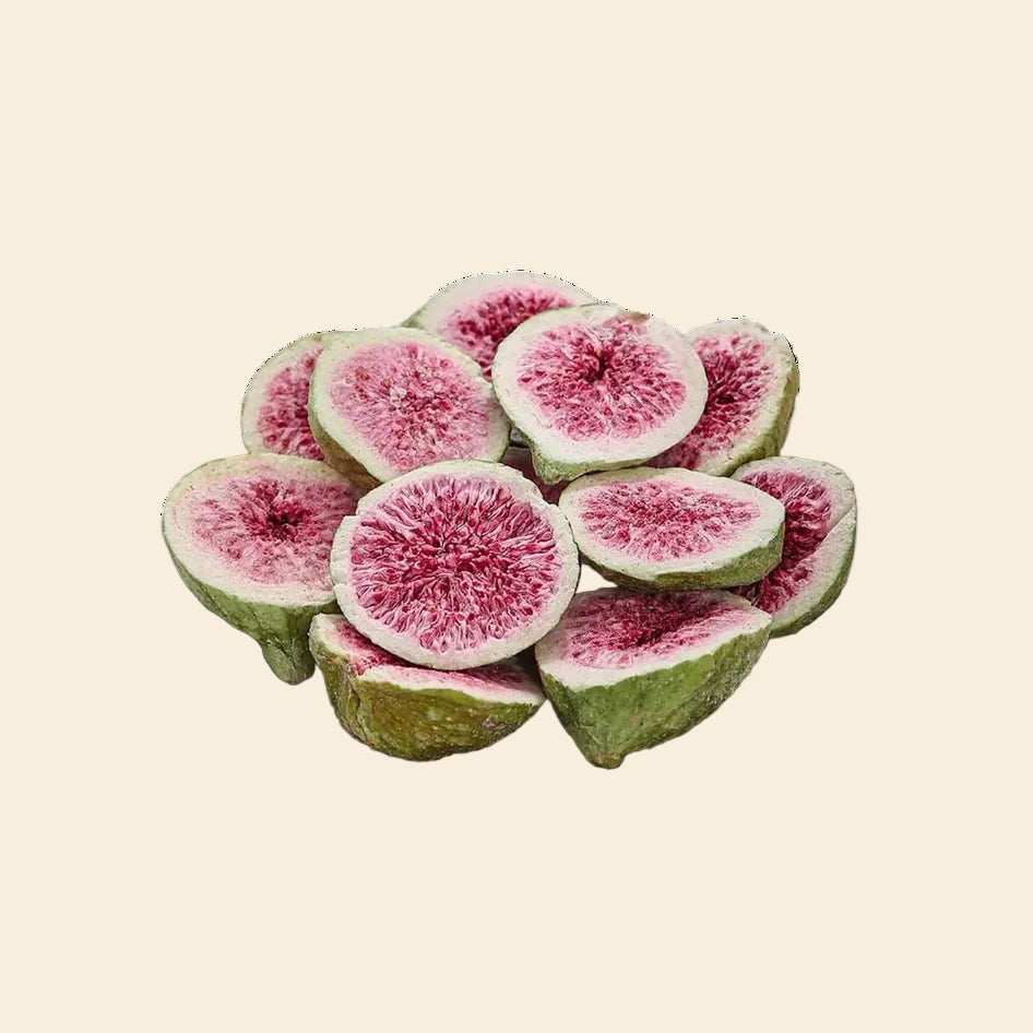 Multiple freeze-dried figs, showing their natural green skin and vibrant pink interior, highlighting the crunchy, single-ingredient healthy dog treat.