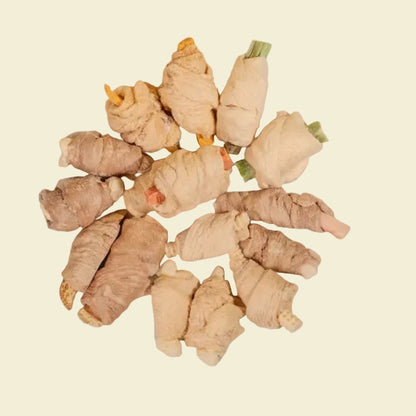 A top-down view of various freeze-dried mixed wrapped bites, showcasing premium chicken and duck breast wrapped around superfoods like okra, pumpkin, and cheese.