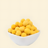 A white bowl overflowing with bright golden, round freeze-dried quail egg yolks on a white background, showcasing a nutrient-dense, single-ingredient treat designed to boost pet skin and coat health.