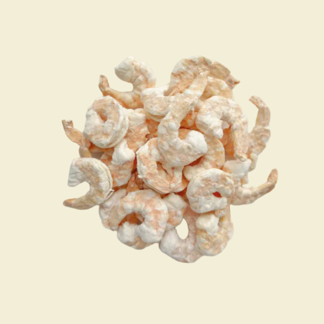 Top-down view of premium freeze-dried whole shrimp pet treats arranged on a white plate, showcasing their natural pink hue and intact whole-prey texture.