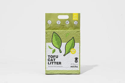Package of tofu cat litter with green tea leaves on a white background