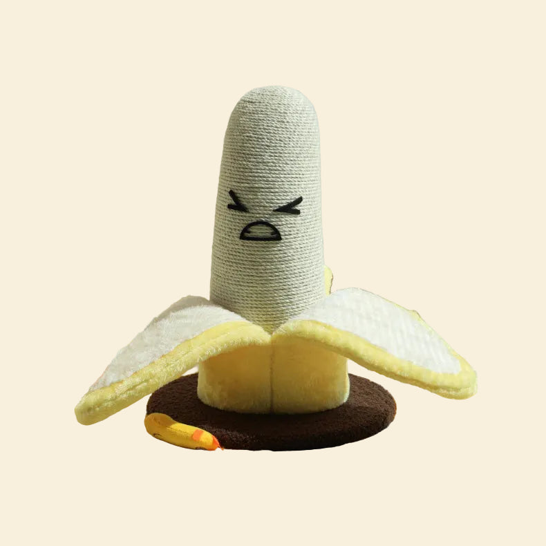 Front view of the hilarious Banana Cat Scratching Post featuring a grumpy embroidered face, hand-woven sisal rope, and soft plush petals folded down over a heavy-duty brown base.