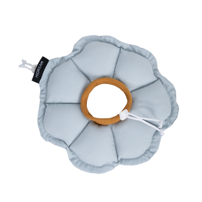 Flat lay of the HiDREAM Upgraded Soft Flower Recovery Collar in Iceland Blue, featuring a cozy ribbed inner neckband and adjustable drawstring on a black background.