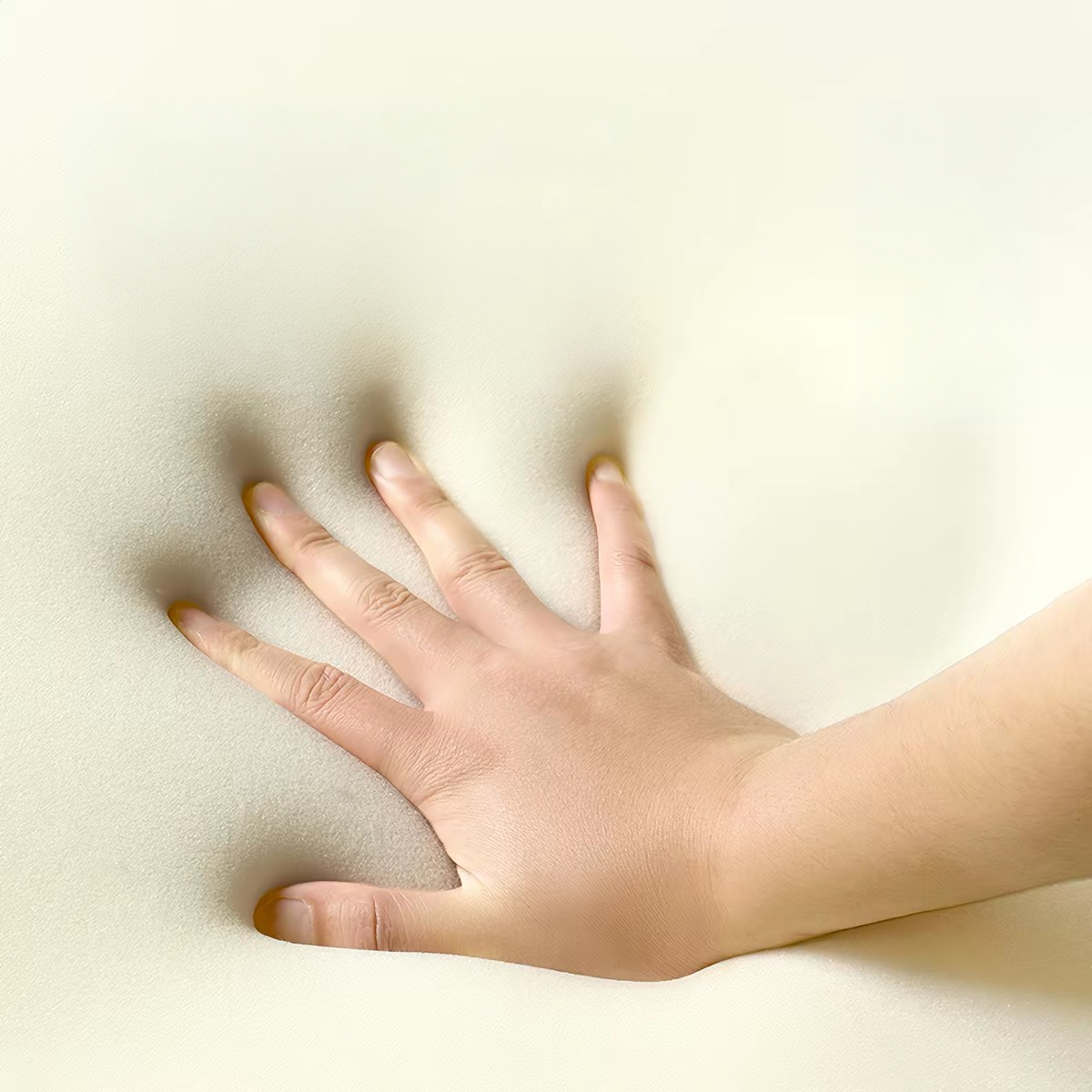 A hand pressing deeply into the premium high-density electronic cotton memory foam of the Mango Pet Bed, demonstrating resilient joint support and comfort.