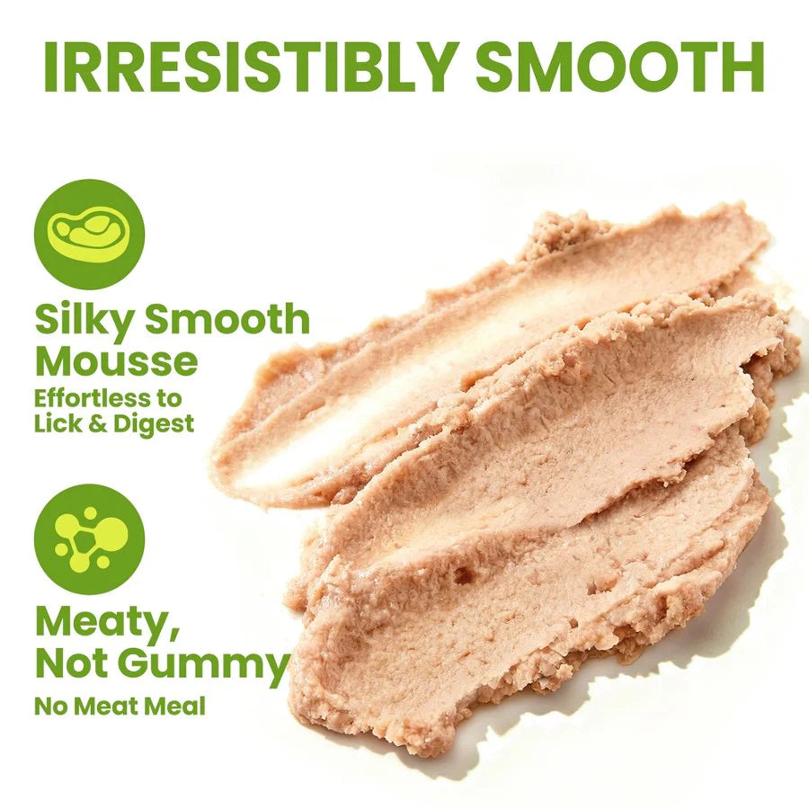 A close-up smear of OPET Yum Creamies cat treat, demonstrating its irresistibly silky smooth mousse texture. Text highlights that it is "Meaty, Not Gummy" with zero meat meal.