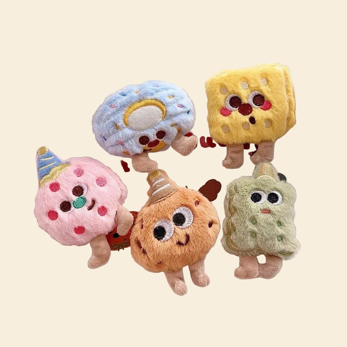 A delightful collection of five kawaii plush bakery squeaky toys, including cookies and biscuits with embroidered faces, beautifully displayed on a checkered picnic cloth.