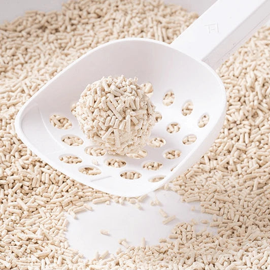 A solid clump of Kungfu Cat natural tofu litter in a white scoop, demonstrating fast 1.5-second clumping performance.