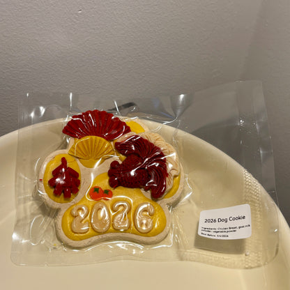 Handcrafted 2026 dog cookie with chicken breast base and goat milk icing.