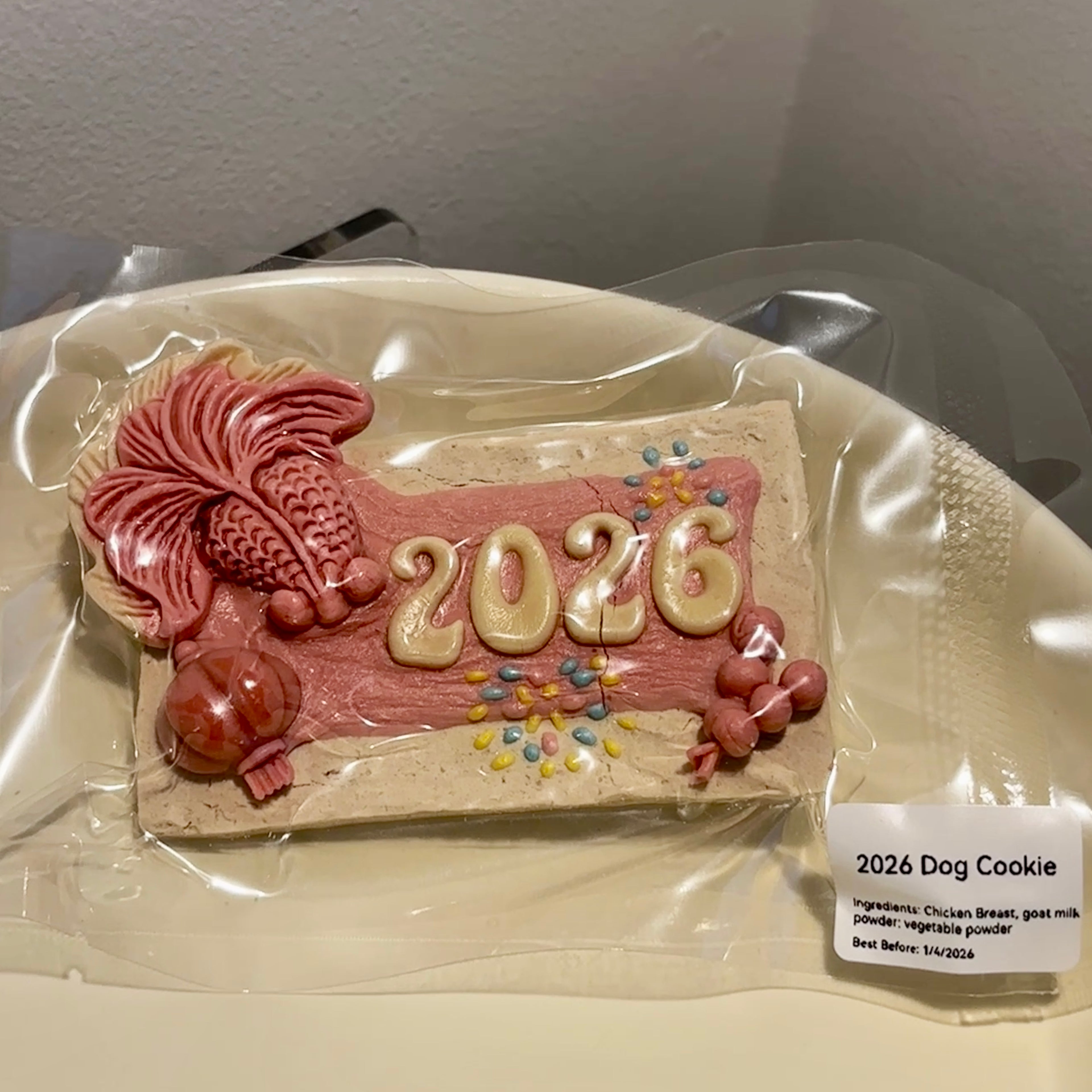 Individually sealed 2026 New Year dog cookie, a grain-free festive gift made with premium chicken breast and goat milk powder.