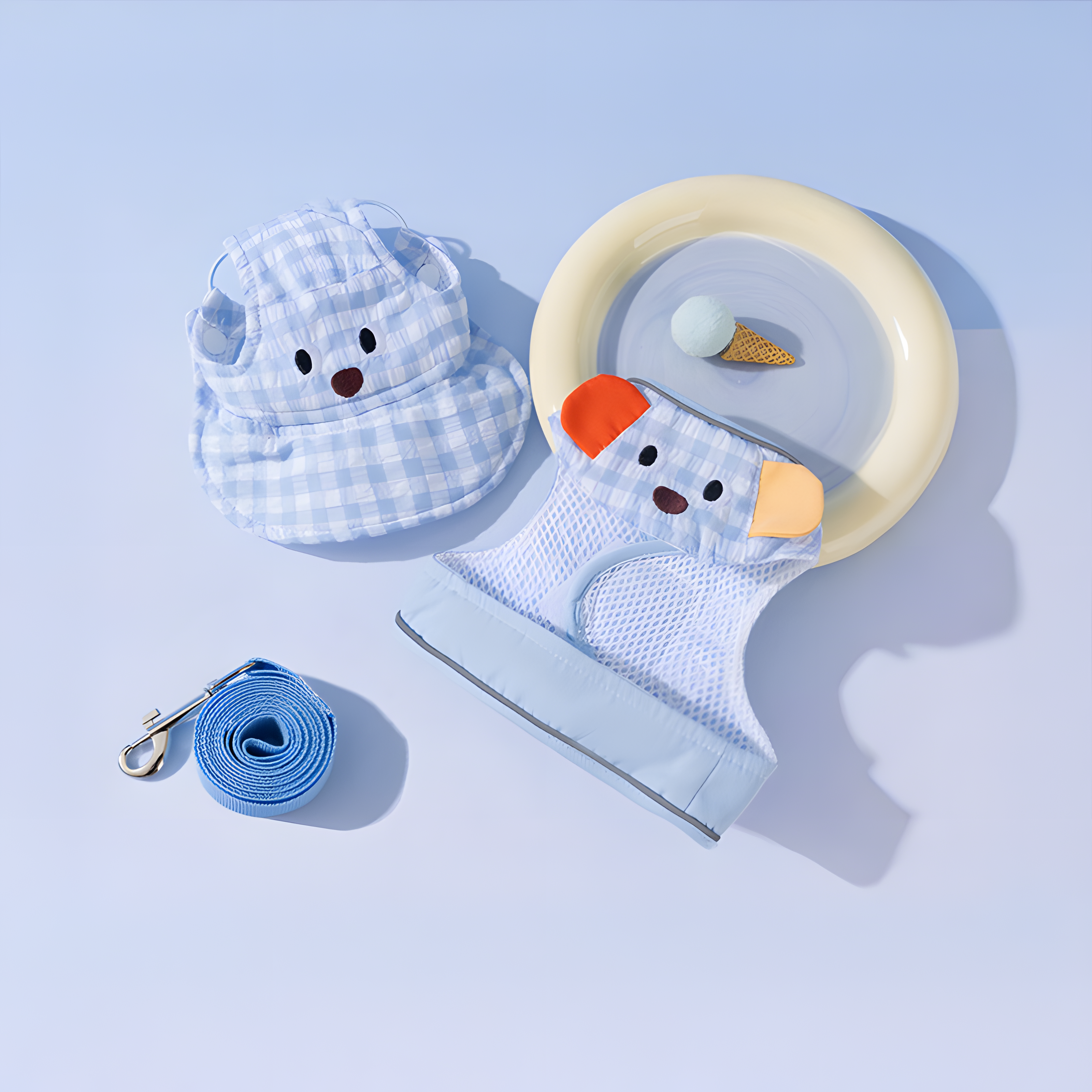 Flat lay of the 3-Piece Signature Set in Blue Plaid Dog design. Includes a breathable mesh harness vest, adjustable sun hat with bear ears, and a matching leash.