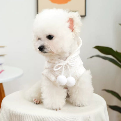 Front view of the dog hoodie showing the adjustable drawstrings and fluffy white pom-poms. The soft collar design ensures a comfortable fit for small breeds