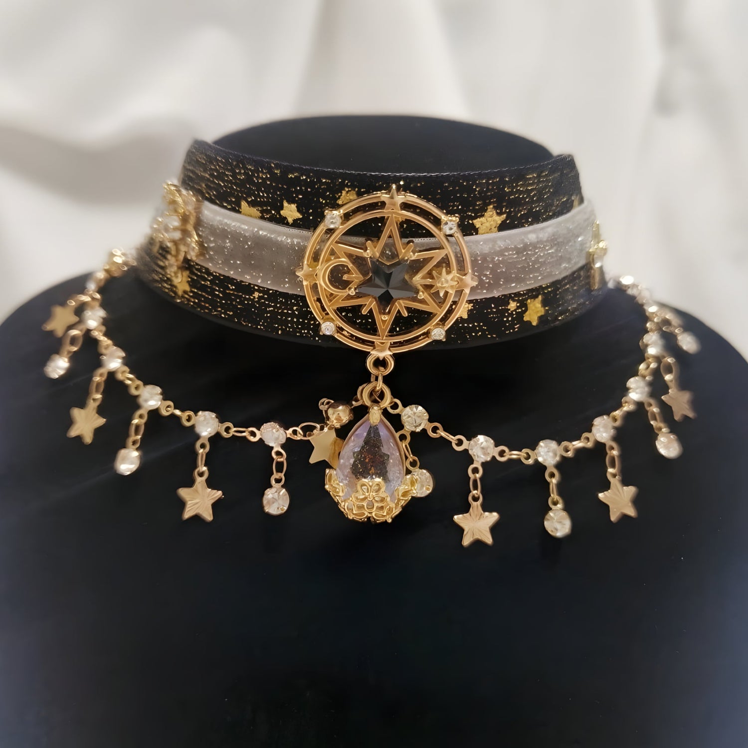 Front view of the celestial cat choker on a display stand. Features a &