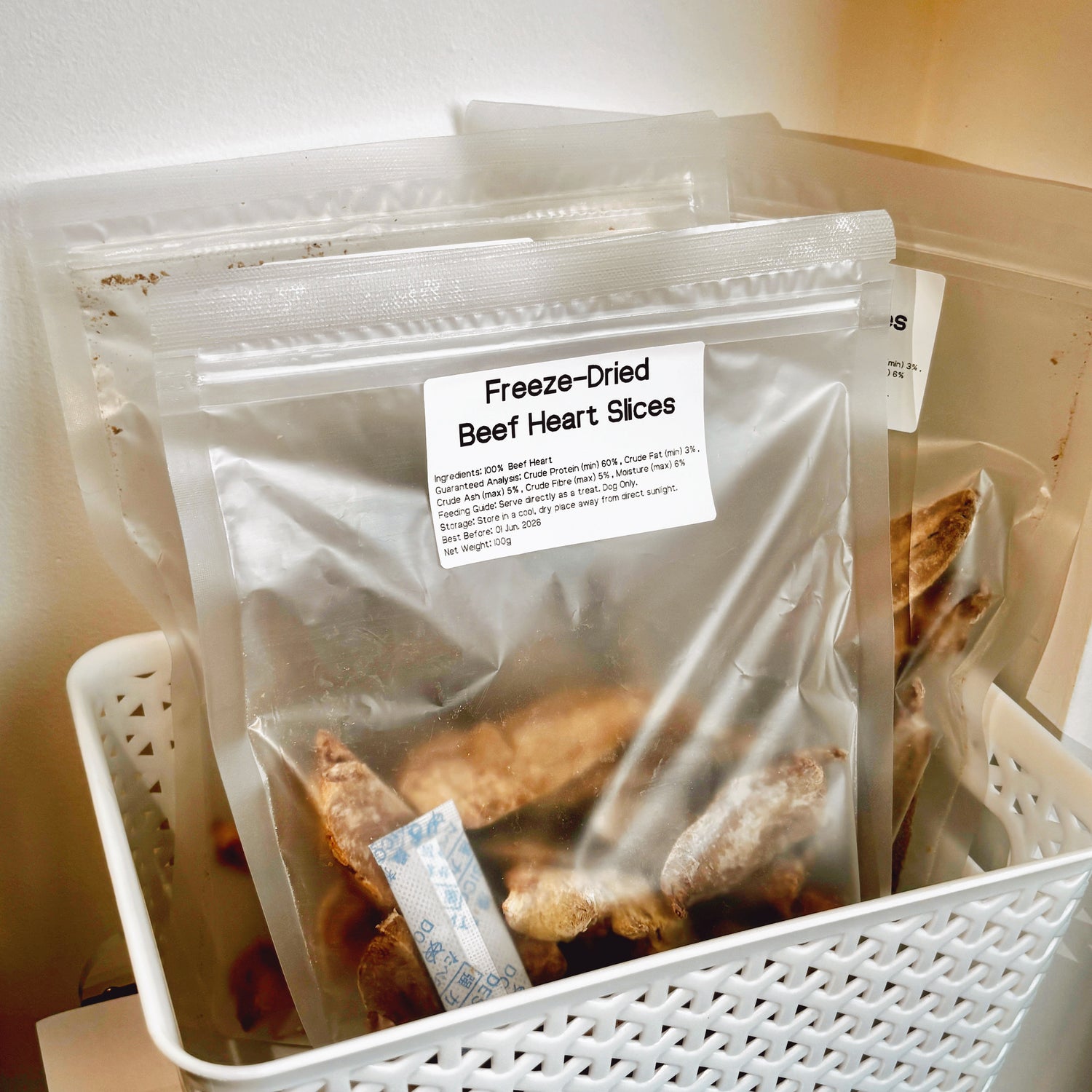 Multiple packs of Beef Heart dog treats in a basket, grain-free and rich in iron and B-vitamins for active and senior dogs.