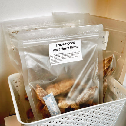 Multiple packs of Beef Heart dog treats in a basket, grain-free and rich in iron and B-vitamins for active and senior dogs.