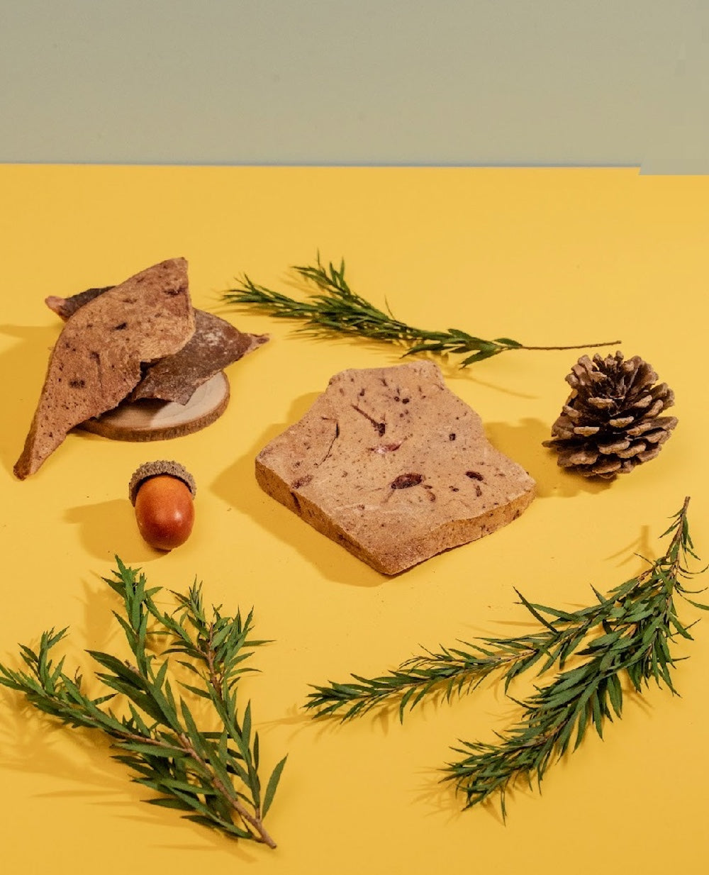 Multiple Lamb Liver chips on a yellow table, grain-free and hypoallergenic treats made in Australia.