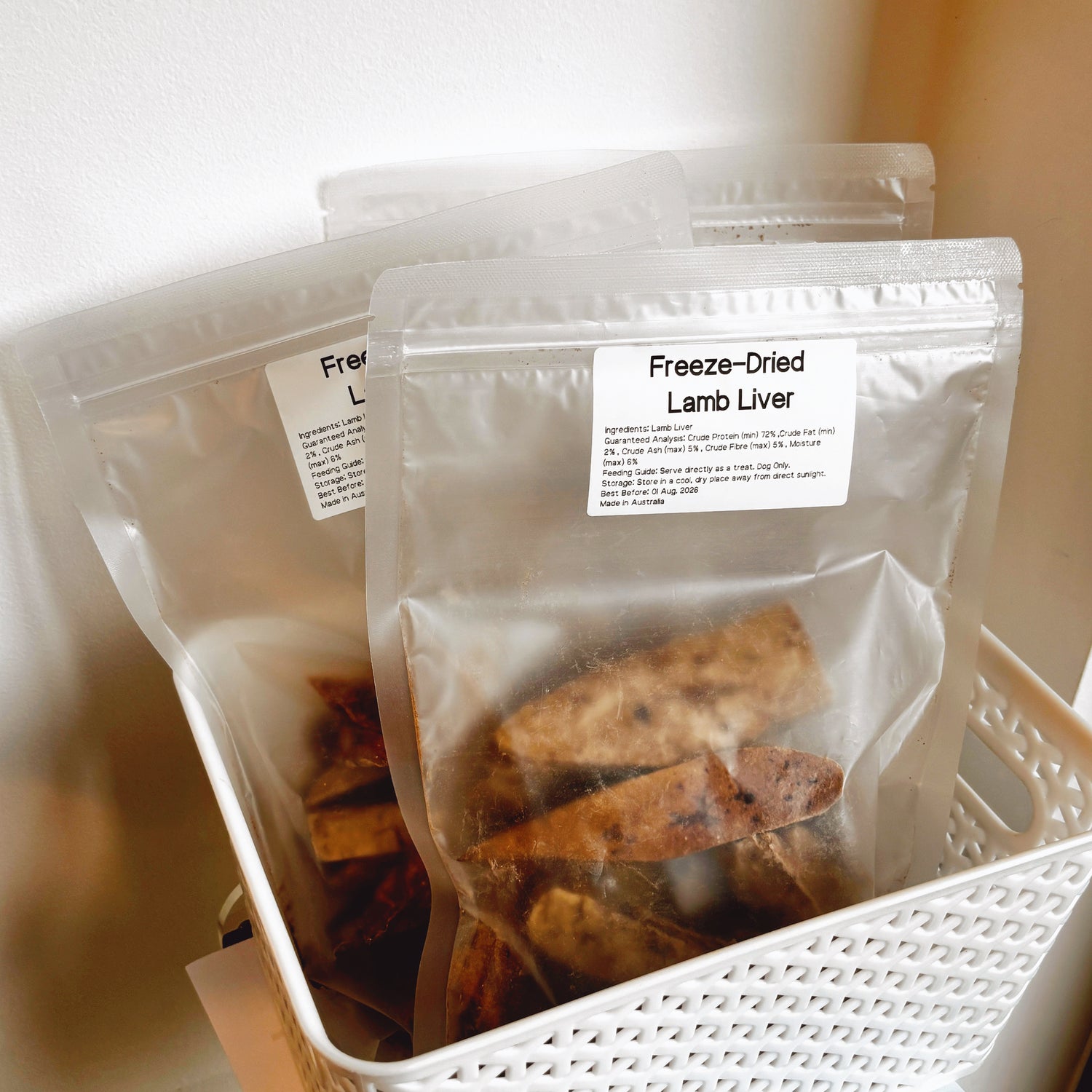 Multiple bags of Lejoyee Lamb Liver chips in a white basket, grain-free and hypoallergenic treats made in Australia.