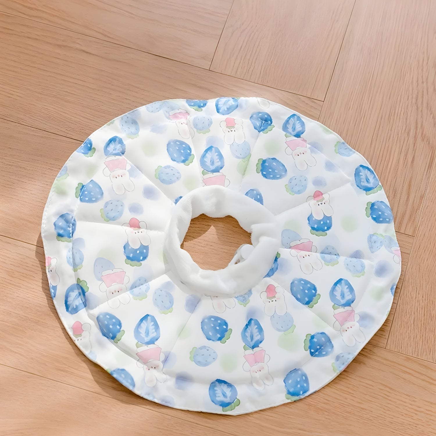 Soft cat recovery collar in a white and blue strawberry bunny print. Lightweight design reduces neck strain and anxiety