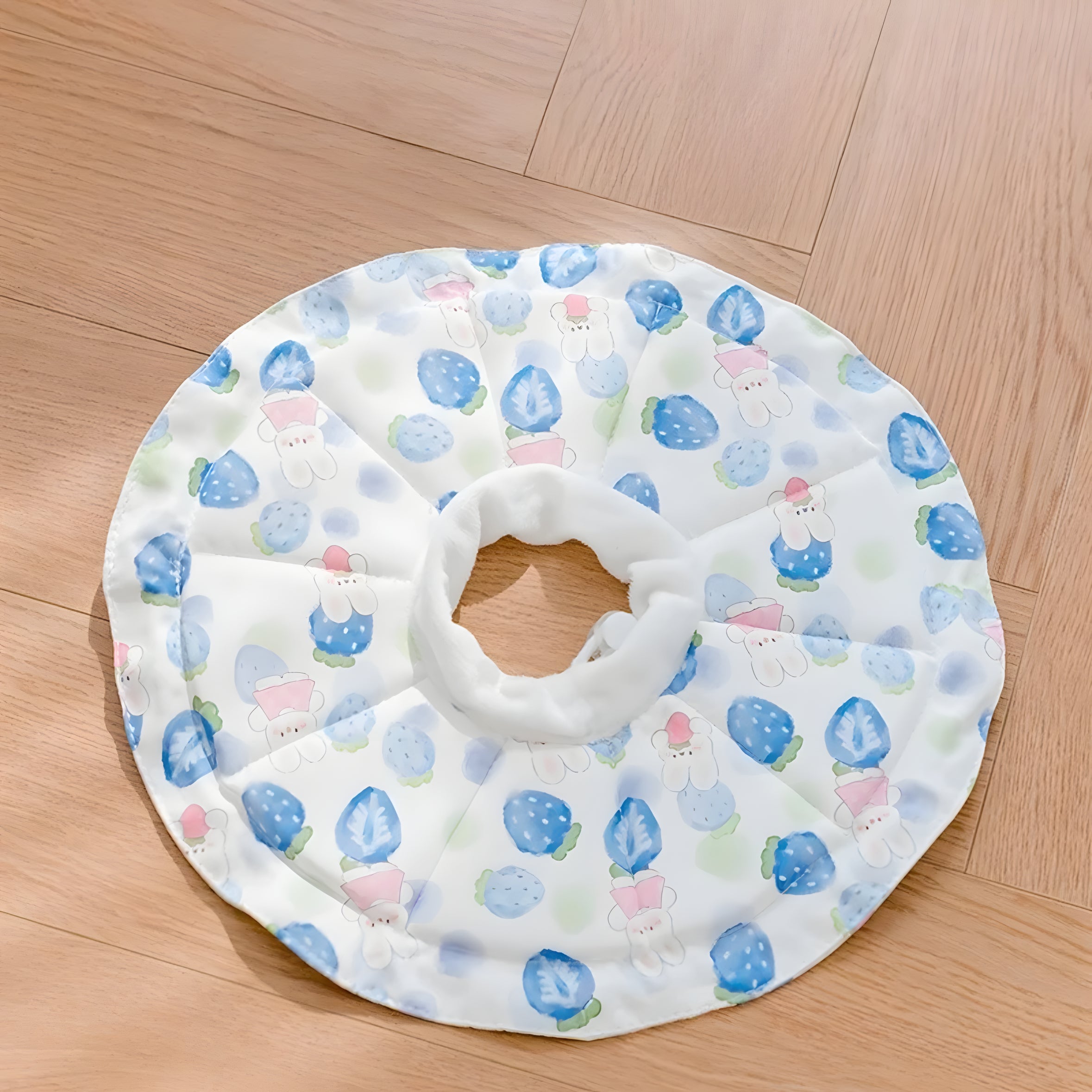 Soft cat recovery collar in a white and blue strawberry bunny print. Lightweight design reduces neck strain and anxiety