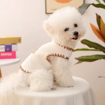 Side profile of a small dog in the white summer vest. The sleeveless silhouette allows for maximum airflow and freedom to zoom without restriction