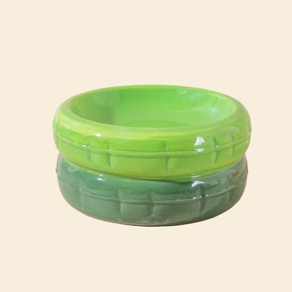 A vibrant two-tone green ceramic cat bowl featuring a lime green top and a forest green base, with a glossy finish and signature textured grooved pattern.