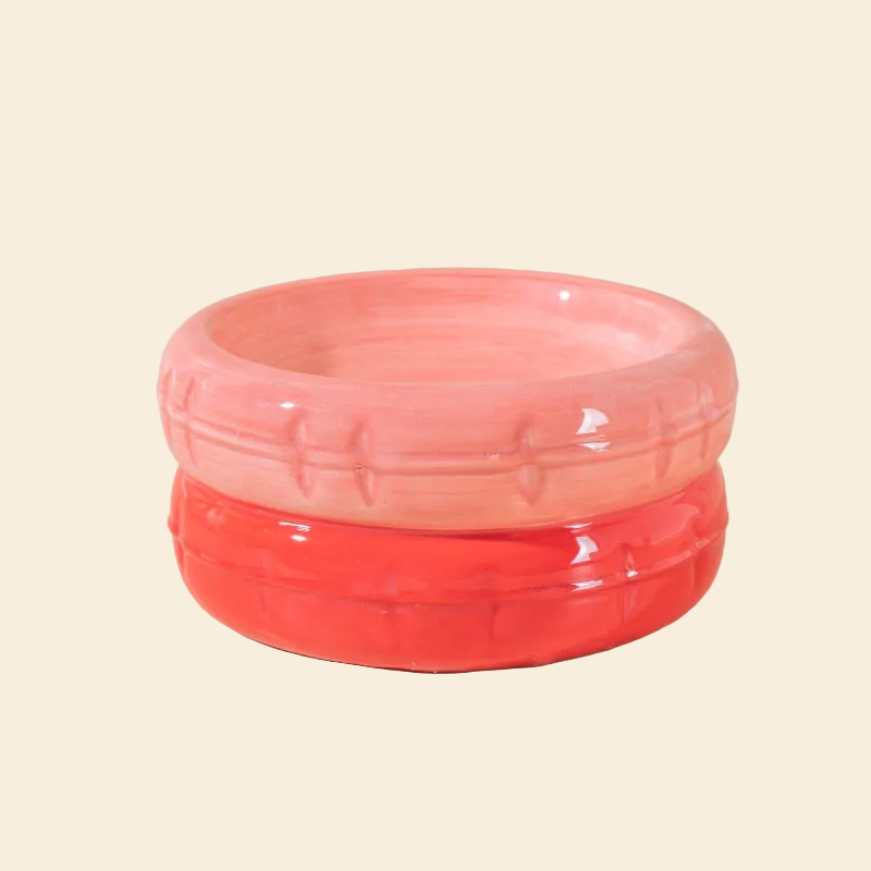 A vibrant two-tone pink ceramic cat bowl with a soft pink top and a warm reddish-orange base, featuring a glossy finish and easy-to-clean surface.