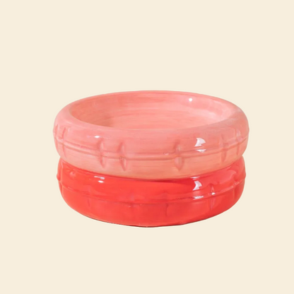 A vibrant two-tone pink ceramic cat bowl with a soft pink top and a warm reddish-orange base, featuring a glossy finish and easy-to-clean surface.