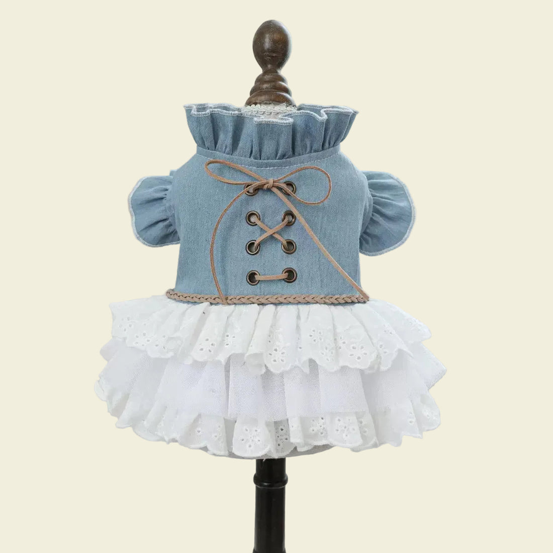 Front display of the western-style dog dress on a mannequin, highlighting the authentic bronze-tone eyelets and soft brown cord corset design