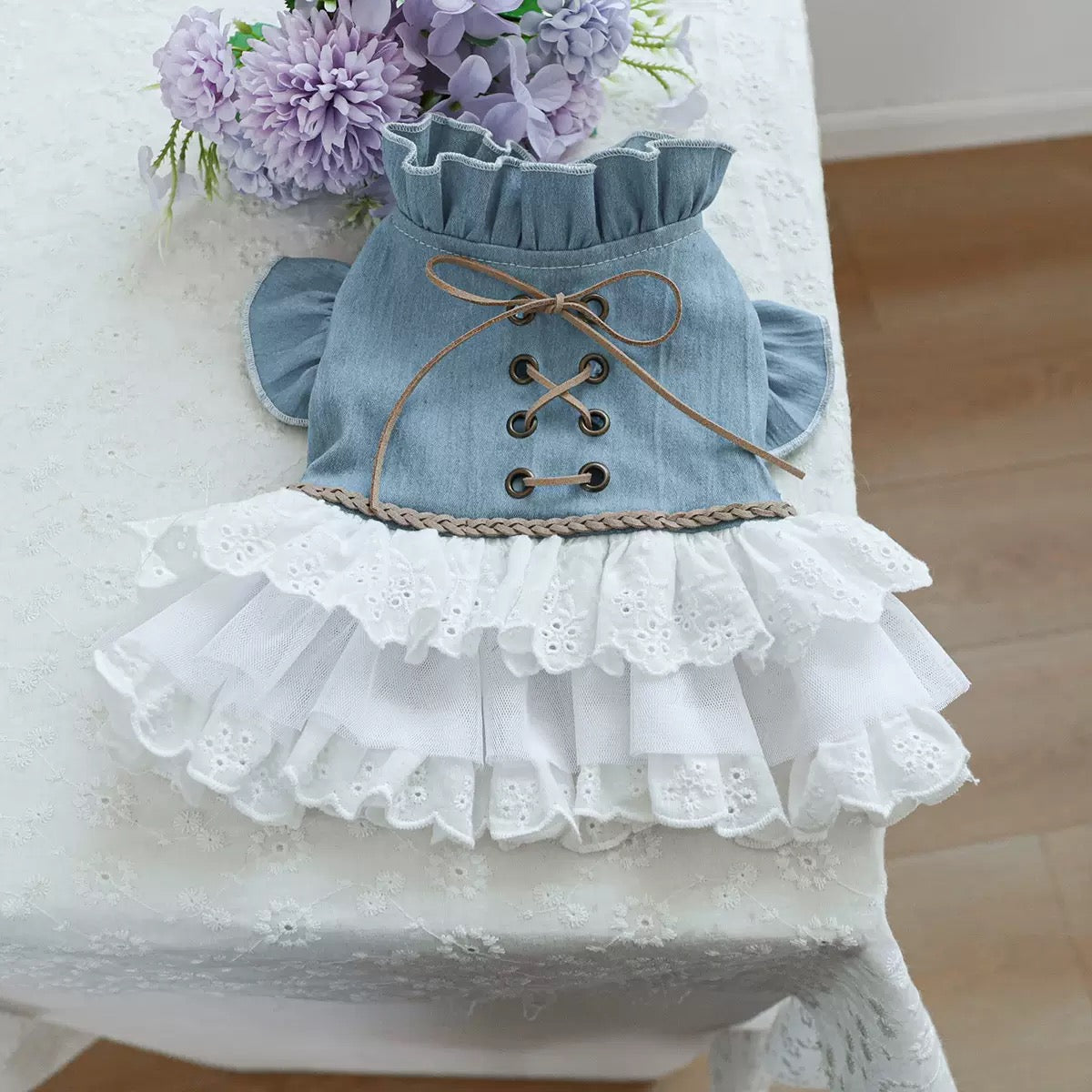 Flat lay of the western denim dog dress showing the intricate braided waist trim and multiple layers of airy tulle for a voluminous tutu effect