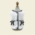 Front view of the Chanel-inspired dog vest on a mannequin. Highlights the symmetrical pearl-centered bows and the sophisticated &