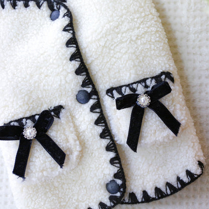 Close-up of the plush velvet bows with sparkling pearl centers. These chic accents turn any sidewalk into a runway for your fashionable pet