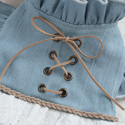 Macro shot of the corset-style lace-up back on the denim bodice. Designed for a vintage look without the squeeze, ensuring maximum pet comfort