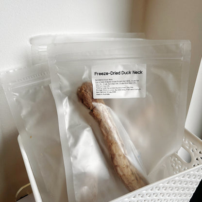 Multiple bags of duck neck dental treats in a basket, long-lasting natural chews for dog mental enrichment and oral health