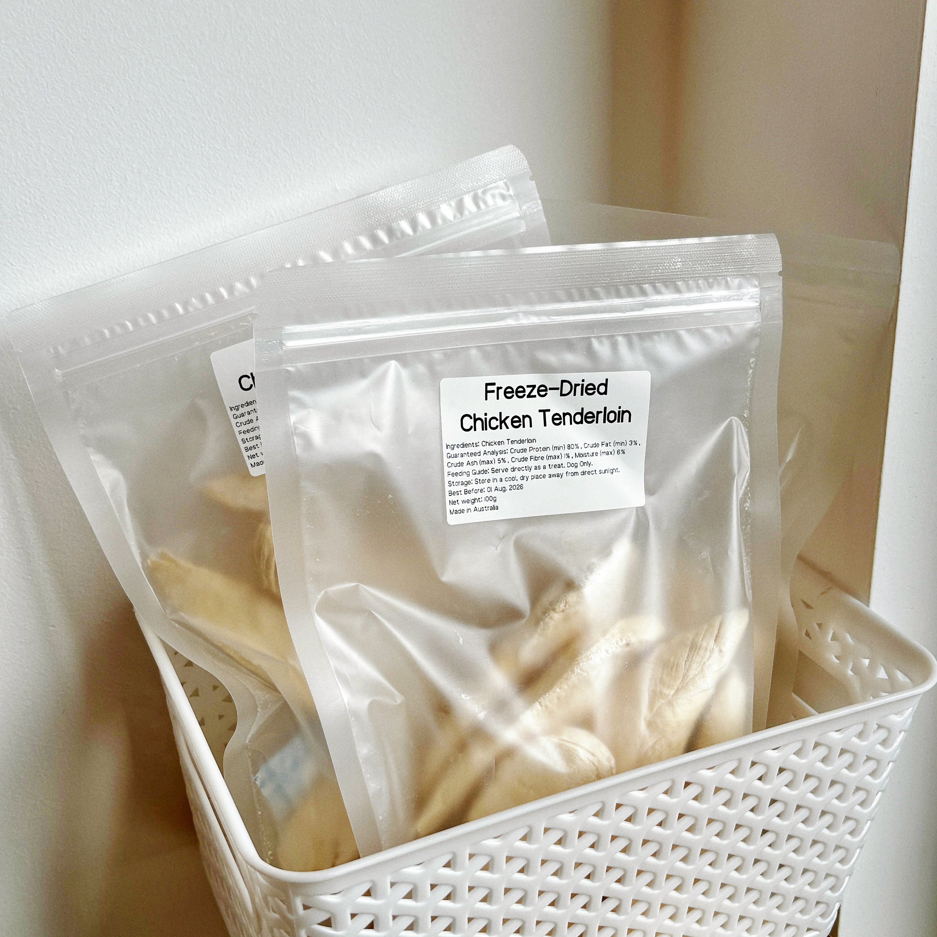 Multiple bags of Freeze-Dried Chicken Tenderloin (100g) in a white basket, grain-free high protein dog training rewards made in Australia