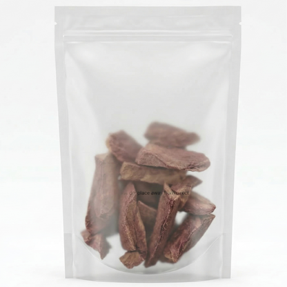 Multiple Beef Heart dog treats in a plastic bag, grain-free and rich in iron and B-vitamins for active and senior dogs.