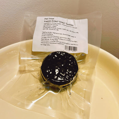 Individually sealed freeze-dried dog cookie pouch, showing natural ingredients like chicken breast, squid ink, and Chinese yam.