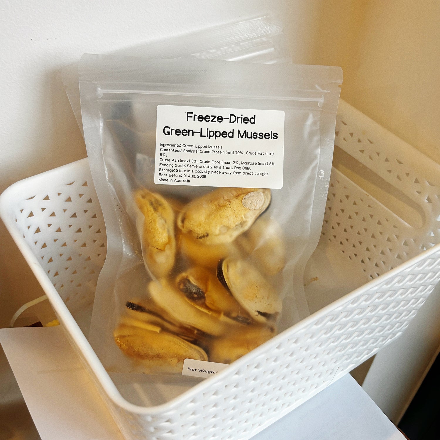 Multiple bags of green-lipped mussels in a basket, a potent natural anti-inflammatory superfood for senior dogs and active breeds.