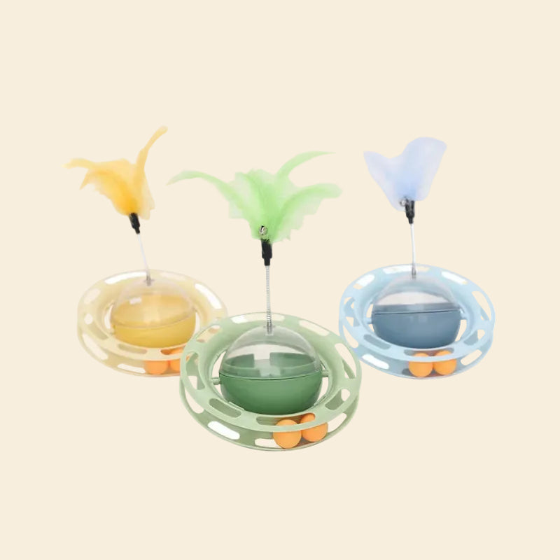 Collection of 4-in-1 Enrichment Hub toys in yellow, green, and blue. Each features a feather teaser, treat dispenser dome, and track balls.