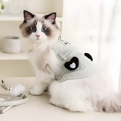 Side view of a cat wearing the sage green Panda Harness Dress. Features a secure wrap-around design with heart pockets and a panda patch to prevent escaping