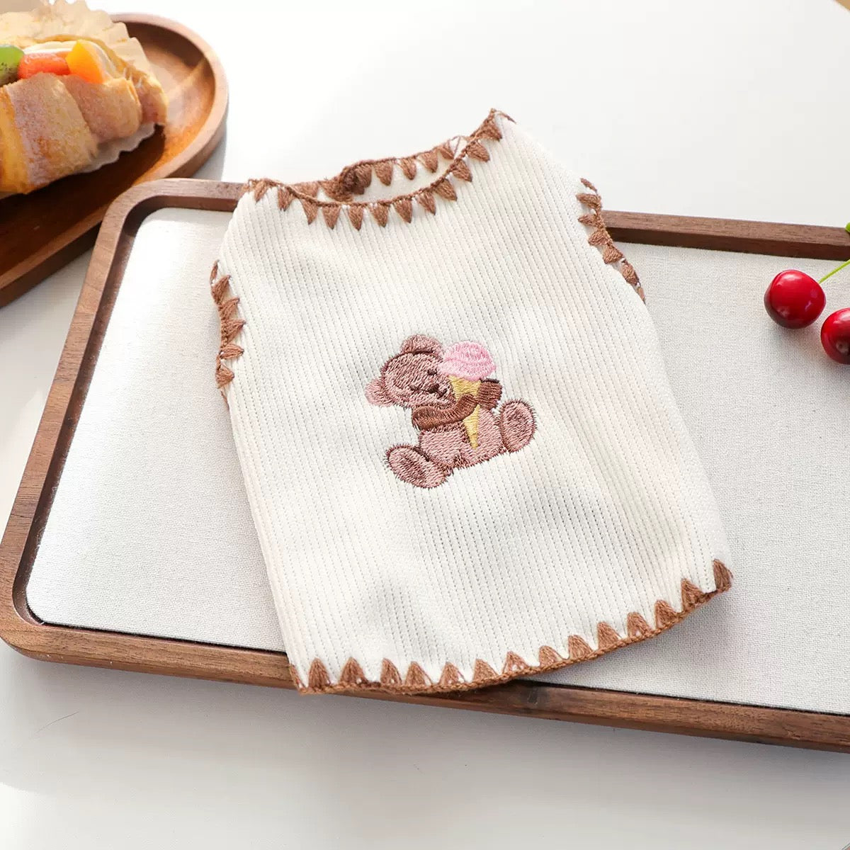 Flat lay of the white knitted dog tank. Features a whimsical bear and ice cream print designed to spark smiles on sunny days
