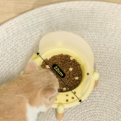 Top view of a cat eating from the Mango Feeder in yellow, showing the 22cm wide whisker-friendly ceramic bowl that prevents whisker fatigue