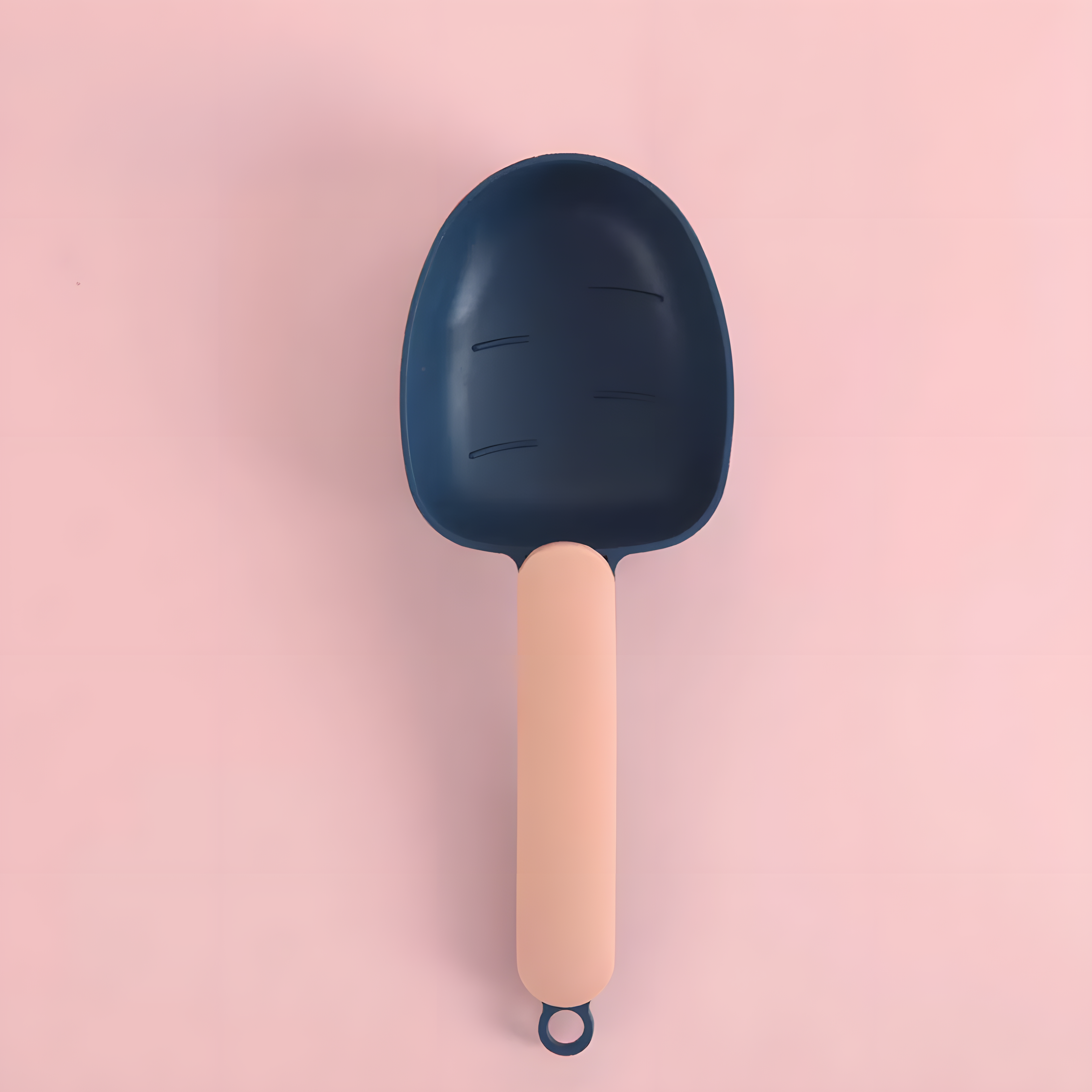 Close-up of the Navy and Peach cat food scoop. The deep, rounded bowl is shaped to hold a generous portion of dry food for mess-free serving