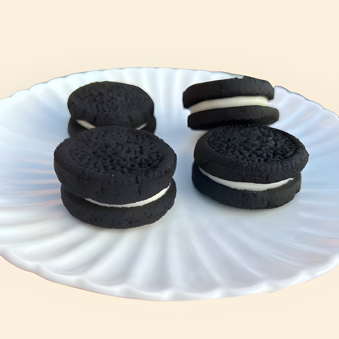 Two sets of Dog Oero cookies with white filling on a white plate.